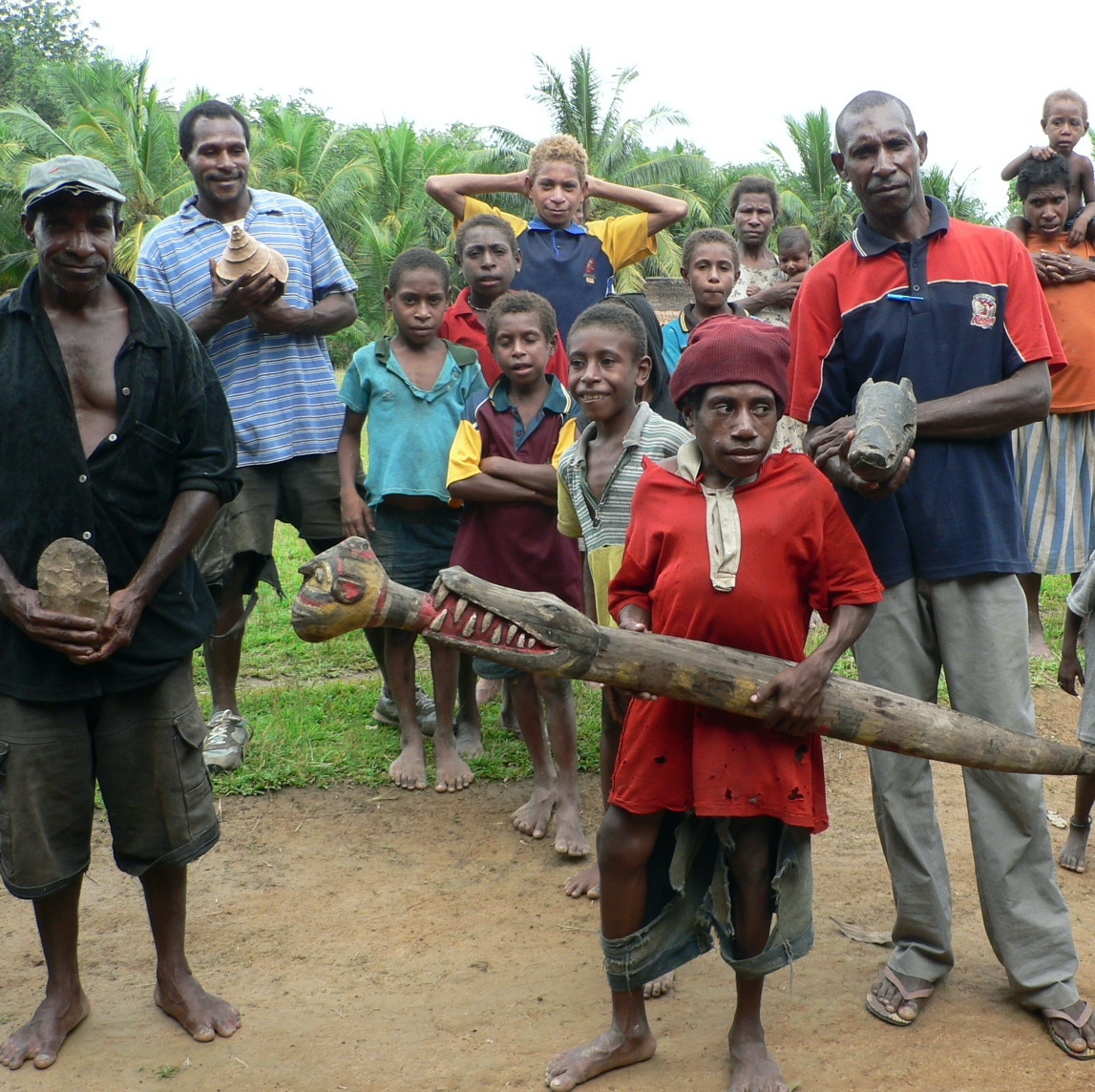 Some folks from the Gogodala area holding some artifacts for sale.  Photo by Greg Hamson, circa 2008.