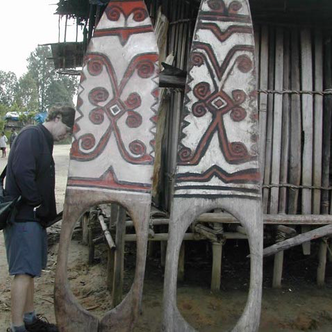 Inspecting two nice Telefomin doorboards, amitung, West Sepik Province, Papua New Guinea.  Pretty sure I bought both of them.