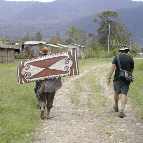 Walking through Telefomin station with nice but not ancient war shield, West Sepik Province, Papua New Guinea, circa 2004/5.