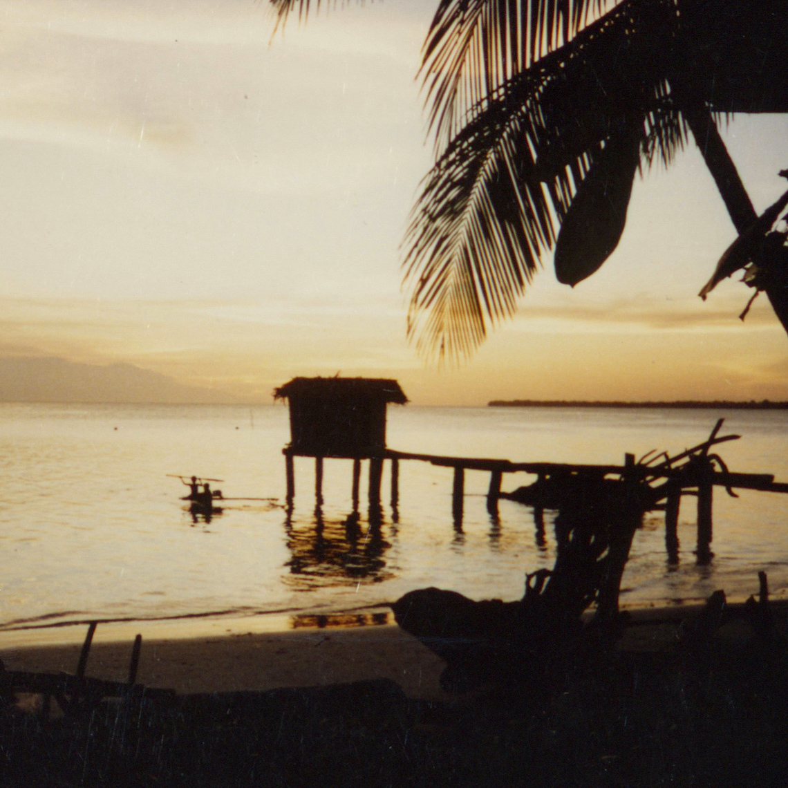 Picturesque Vokeo Island toilet, “the long drop”, with a school of hungry fish always ready waiting below.  Papua New Guinea, circa 1995.